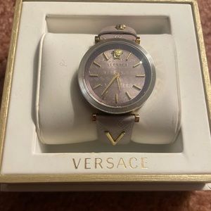 Woman’s Versace watch. Very light purple. Almost grey color with gold.